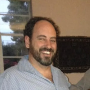 Jeremy Cooper smiling, in a light blue shirt