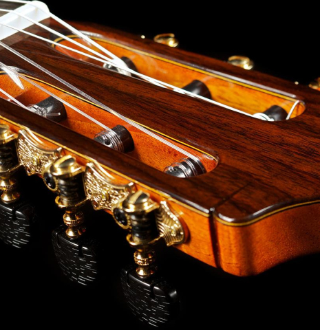 The headstock and tuning machines of a Cordoba "C9" classical guitar made of cedar and mahogany