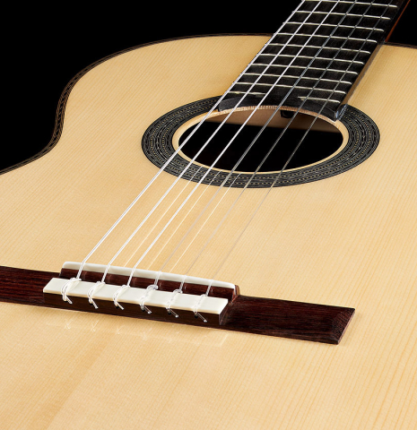 The soundboard of a Cordoba Guitars Master Series "Torres" classical guitar made of spruce and Indian rosewood