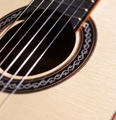 The rosette and spruce soundboard of Cordoba C12 classical guitar