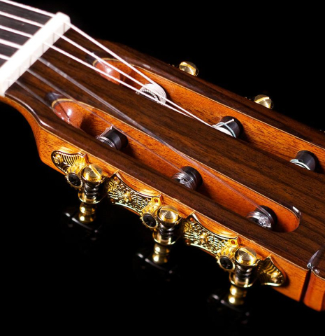 The headstock and machine heads of Cordoba C12 classical guitar