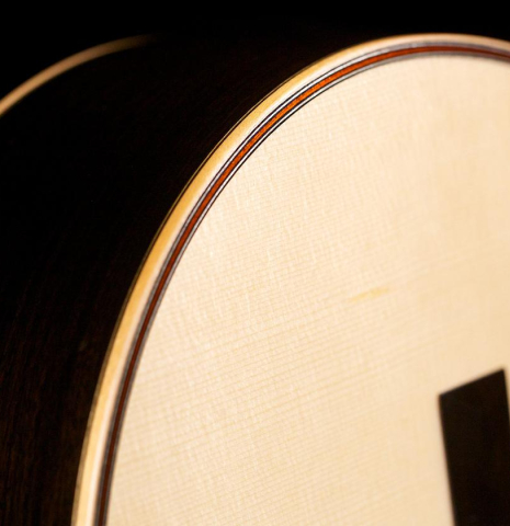 The soundboard and binding of Cordoba C12 classical guitar