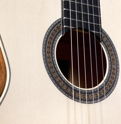 The soundboard and rosette of Cordoba "45 Limited" SP/EB classical guitar made with spruce top and White Ebony back and sides