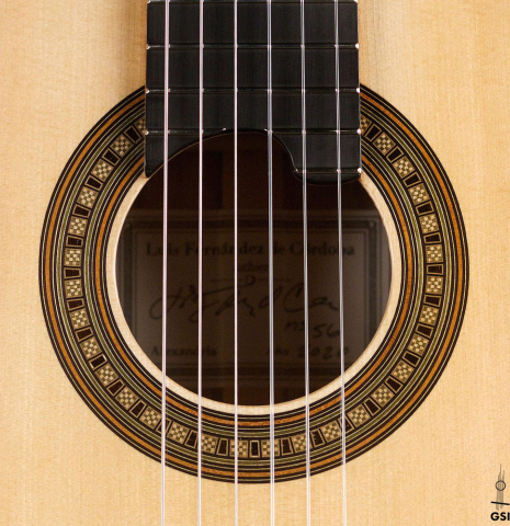 The rosette of a 2020 Luis Fernandez de Cordoba classical guitar made of spruce and black limba wood.