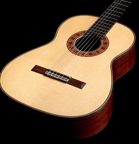 The soundboard of a 2022 Cordoba &quot;20th Anniversary&quot; classical guitar made of spruce and African rosewood