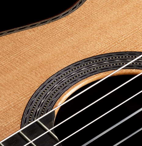 The soundboard and rosette of a Cordoba Guitars Master Series "Torres Lefty" classical guitar made of cedar and Indian rosewood