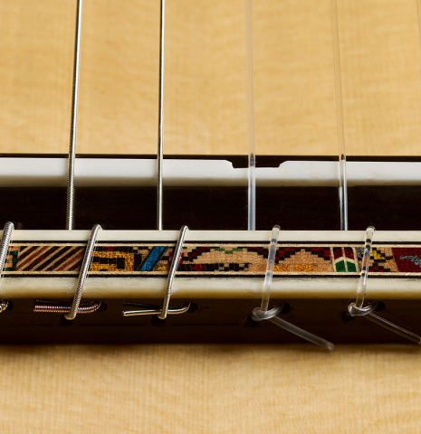 The bridge, tie-block and saddle of a 2026 Andy Culpepper "15th Anniversary" SP/CSAR classical guitar made of spruce and CSA rosewood