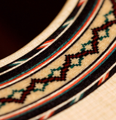 A close-up of the rosette of a 2021 Andy Culpepper classical guitar made of spruce and cypress