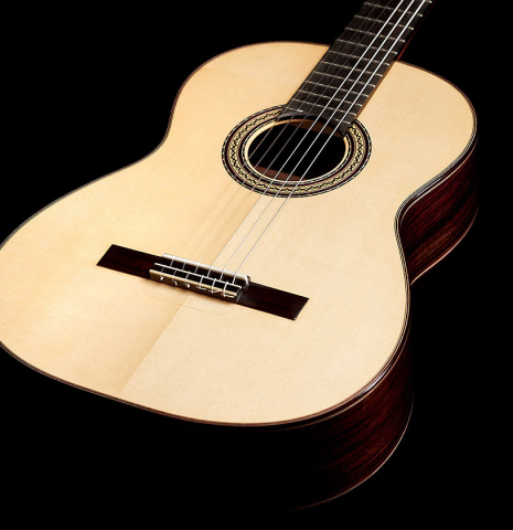 The top of a 2022 Andy Culpepper &quot;Lefty&quot; classical guitar made of spruce and Indian rosewood