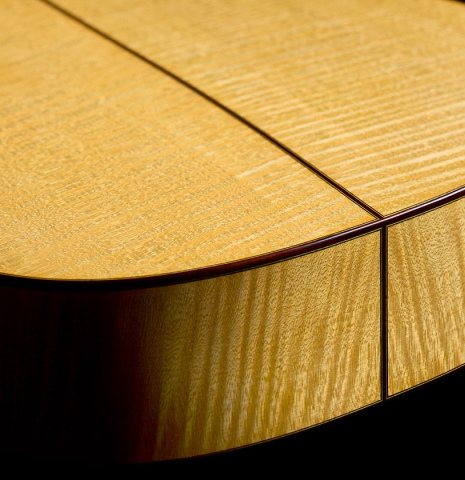 The back and sides at the foot of a 2026 Andy Culpepper "Santos" classical guitar made of spruce and maple