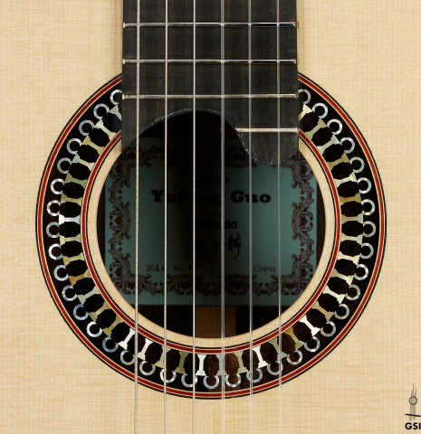 The rosette of a 2020 Yulong Guo "Granada" classical guitar made of spruce and CSA rosewood