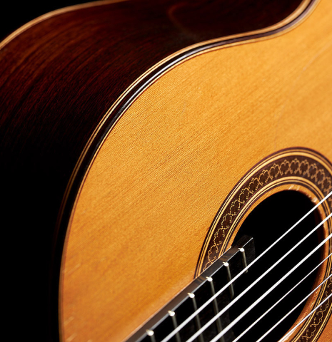 The soundboard and side of a 1998 David Daily classical guitar made of cedar and Indian rosewood