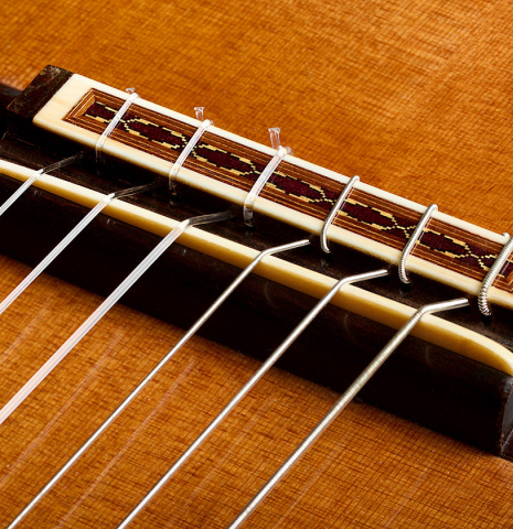 The bridge, tie-block and saddle of a 2000 Matthias Dammann classical guitar (ex Scott Tennant) made of cedar and CSA rosewood