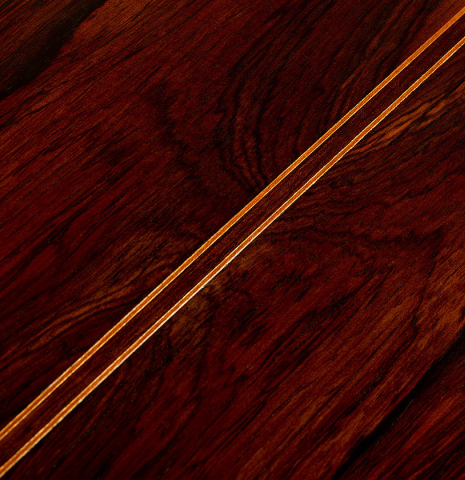 The back center seam of a 1999 Matthias Dammann double-top classical guitar made of cedar and CSA rosewood