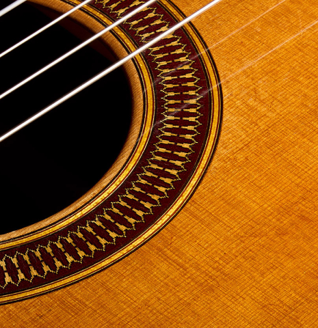 The soundboard and rosette of a 1999 Matthias Dammann double-top classical guitar made of cedar and CSA rosewood