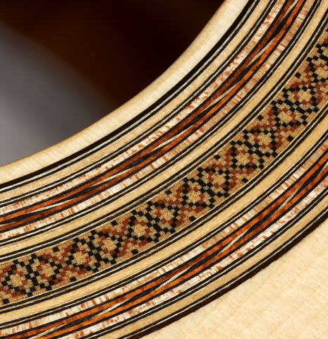 Closeup of the rosette of a 2023 Thomas Dauge classical guitar made of spruce and Indian rosewood