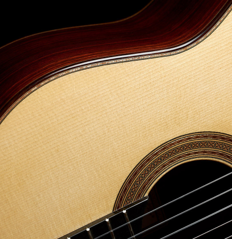 The soundboard and rosette of a 2023 Thomas Dauge classical guitar made of spruce and Indian rosewood
