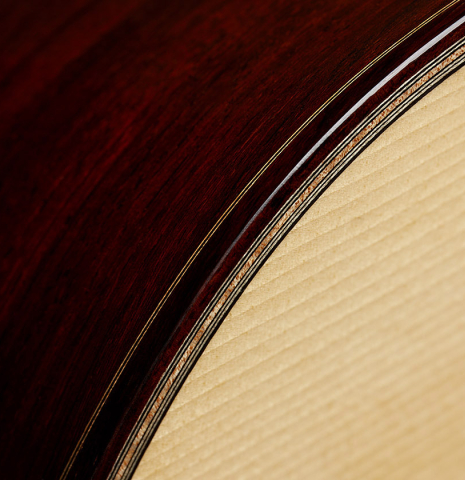 The top binding and purfling of a 2025 Thomas Dauge classical guitar made of spruce and African rosewood