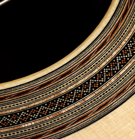 Detailed close-up of the rosette of a 2025 Thomas Dauge classical guitar made of spruce and African rosewood