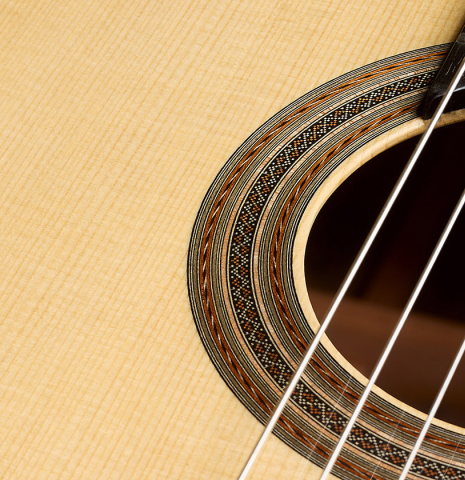 The soundboard and rosette of a 2026 Thomas Dauge classical guitar made of spruce and African rosewood