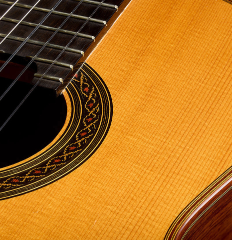 The soundboard and rosette of a 1993 Christopher Dean classical guitar made of spruce and Indian rosewood