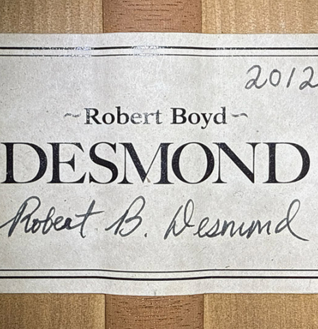 The label of a 2012 Robert Desmond "cutaway w/electronics" classical guitar made of spruce and cypress