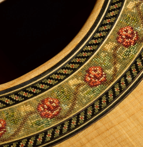 Closeup detail of the rosette of a 2012 Robert Desmond "cutaway w/electronics" classical guitar made of spruce and cypress