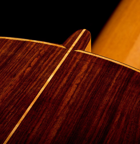 The heel, back binding and purfling of a 2015 Ethan Deutsch w/pegs flamenco negra guitar made of spruce and CSA rosewood
