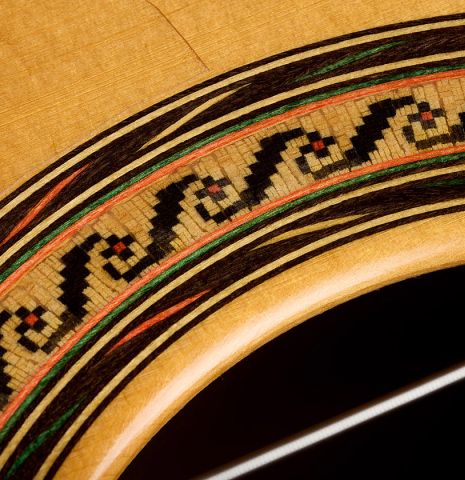 The rosette detail of a 2015 Ethan Deutsch w/pegs flamenco negra guitar made of spruce and CSA rosewood