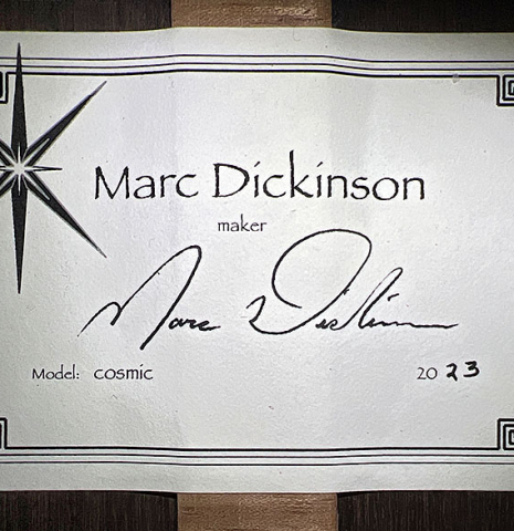 The label of a 2023 Marc Dickinson “Cosmic” classical guitar made of cedar and Indian rosewood