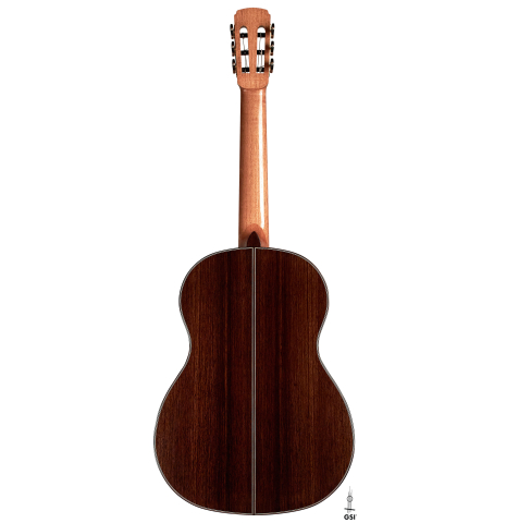 The back of a 2023 Marc Dickinson “Cosmic” classical guitar made of cedar and Indian rosewood on a white background