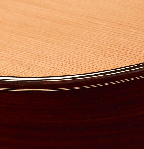 The top, sides and purfling of a 2023 Marc Dickinson “Cosmic” classical guitar made of cedar and Indian rosewood