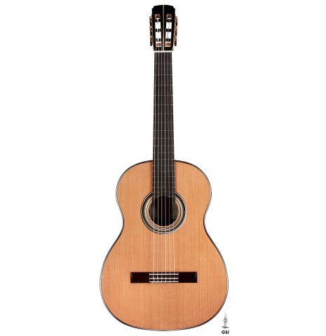The front of a 2023 Marc Dickinson “Cosmic” classical guitar made of cedar and Indian rosewood on a white background