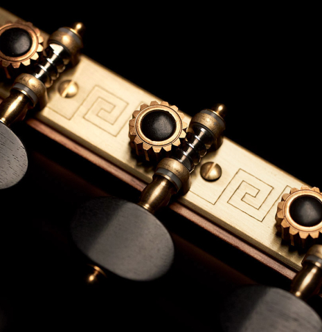 The tuning machines of a 2023 Marc Dickinson “Cosmic” classical guitar made of cedar and Indian rosewood