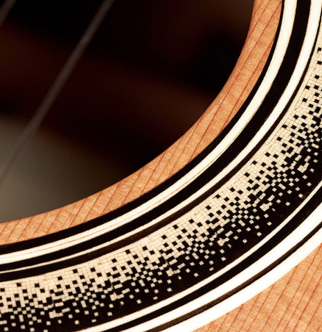 Detail of the rosette of a 2023 Marc Dickinson “Cosmic” classical guitar made of cedar and Indian rosewood