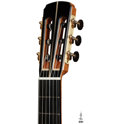 The headstock of a 2024 Marc Dickinson “Cosmic” classical guitar made of cedar and Indian rosewood