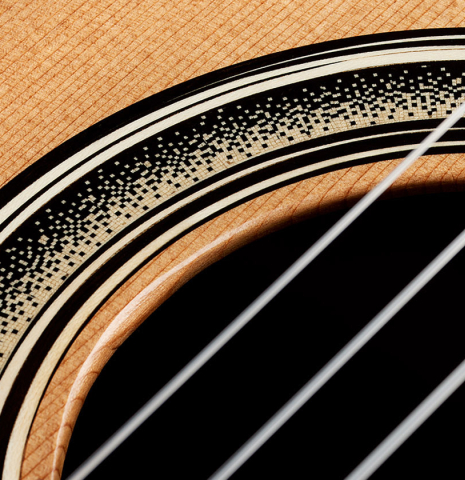 Detailed closeup of the rosette of a 2024 Marc Dickinson “Cosmic” classical guitar made of cedar and Indian rosewood