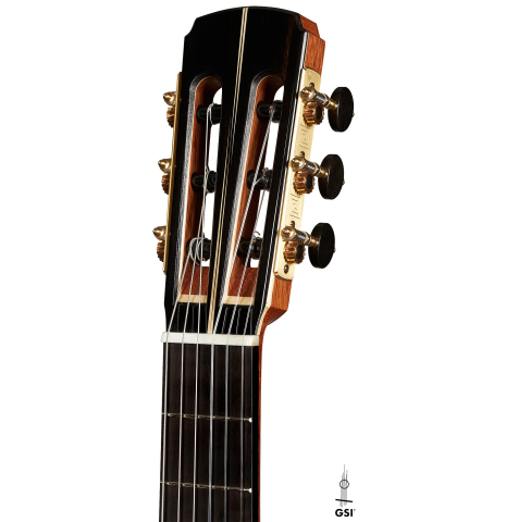 The headstock of a 2023 Marc Dickinson "Cosmic" classical guitar made of spruce and Indian rosewood