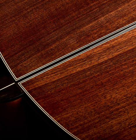 The heel, back binding and purfling of a 2025 Marc Dickinson "Cosmic" classical guitar made of spruce and Indian rosewood