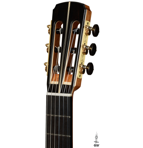 The headstock of a 2025 Marc Dickinson "Cosmic" classical guitar made of spruce and Indian rosewood