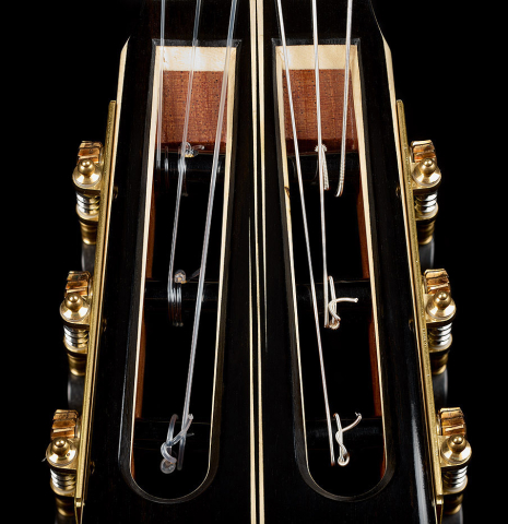 The headstock veneer with inlay of a 2025 Marc Dickinson "Cosmic" classical guitar made of spruce and Indian rosewood
