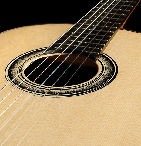 The soundboard of a 2025 Marc Dickinson "Cosmic" classical guitar made of spruce and Indian rosewood