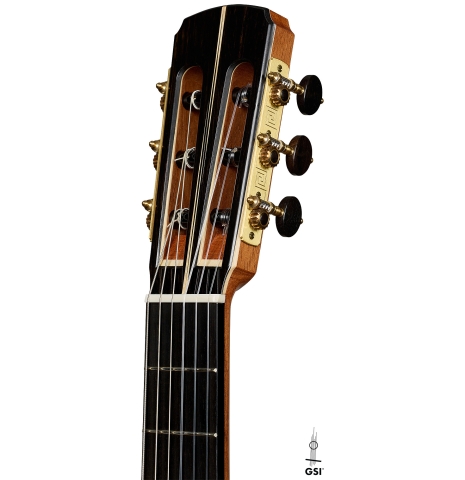 The headstock of a 2026 Marc Dickinson "Cosmic" classical guitar made of spruce and African blackwood