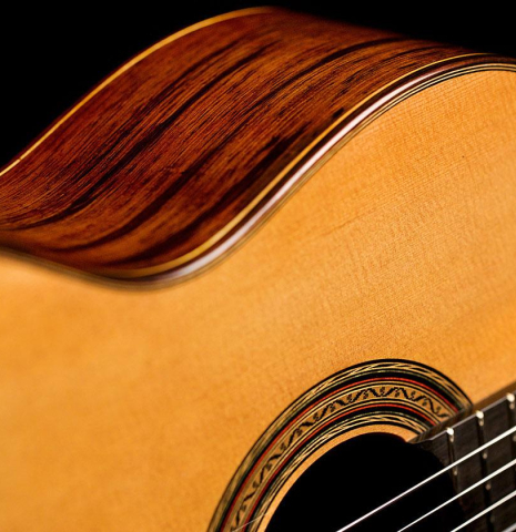 The soundboard and side of a 2020 Vladimir Druzhinin classical guitar made of cedar and African rosewood