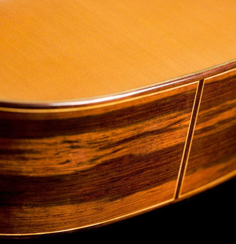 The sides at the foot of a 2020 Vladimir Druzhinin classical guitar made of cedar and African rosewood