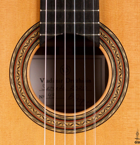 The rosette of a 2020 Vladimir Druzhinin classical guitar made of cedar and African rosewood. The rosette of a 2020 Vladimir Druzhinin classical guitar made of cedar and African rosewood.