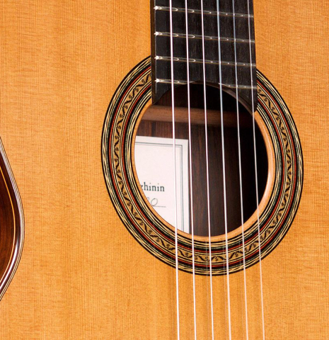 The soundboard of a 2020 Vladimir Druzhinin classical guitar made of cedar and African rosewood. The soundboard of a 2020 Vladimir Druzhinin classical guitar made of cedar and African rosewood.