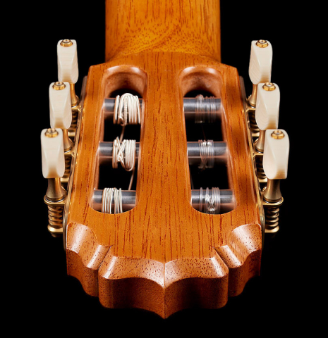 The carved back of the headstock of a 2024 Vladimir Druzhinin classical guitar made with cedar and African rosewood.