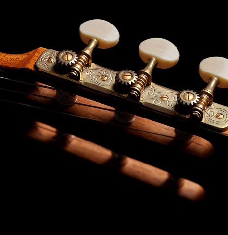 The tuning machine plates and buttons of a 2024 Vladimir Druzhinin classical guitar made with cedar and African rosewood.