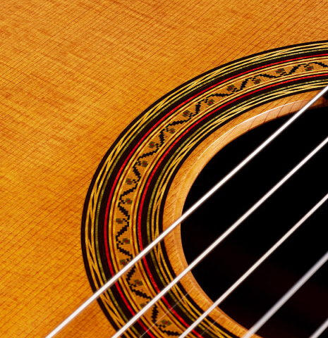 Closeup detail of the rosette of a 2024 Vladimir Druzhinin classical guitar made with cedar and African rosewood.